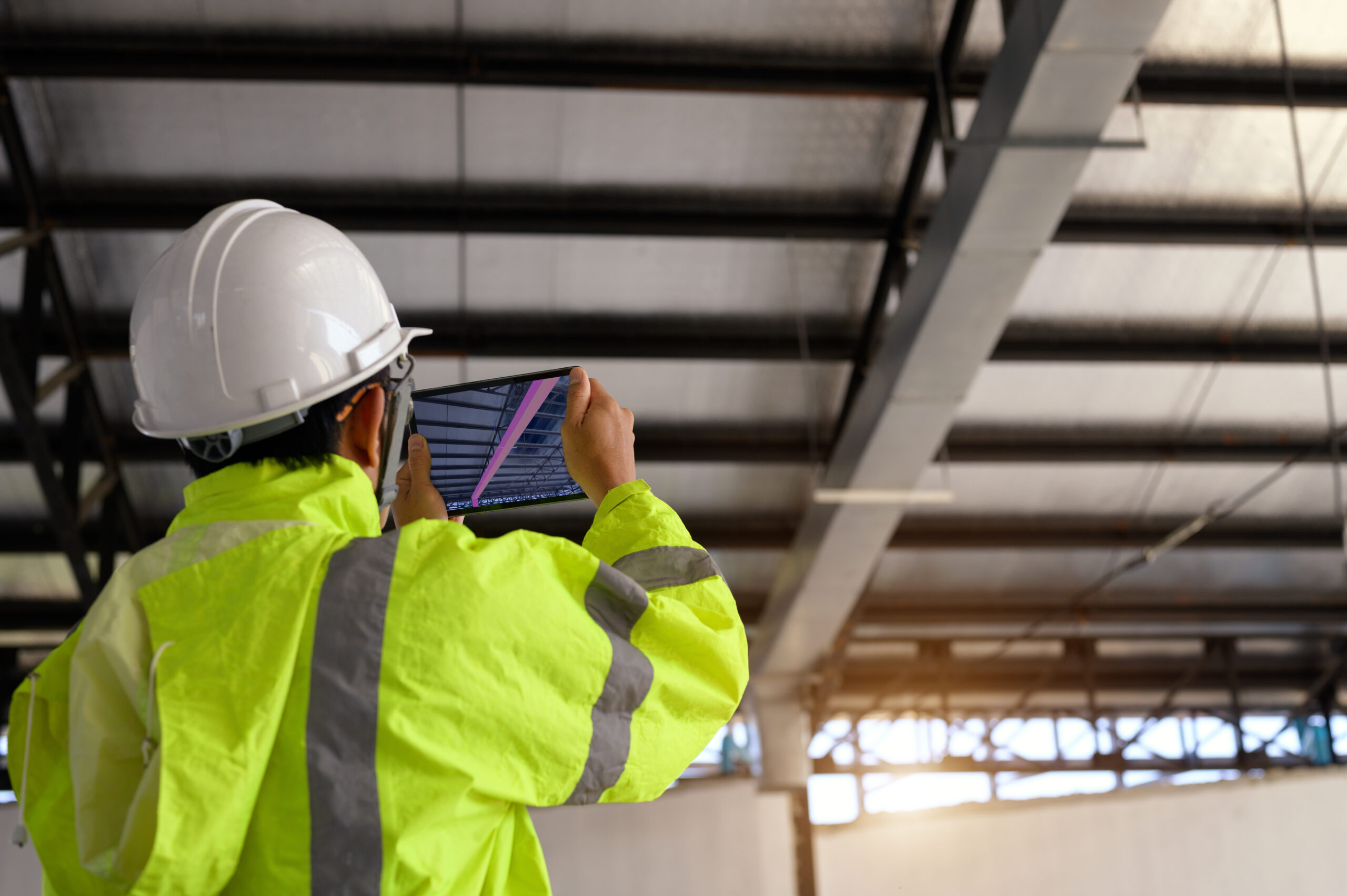 Construction Civil Engineer use technology software through tablets to scan building construction and inspection to show augmented reality in work, Building information model or BIM concept
